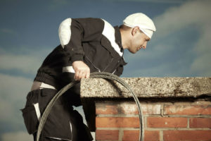 man cleaning chimney
