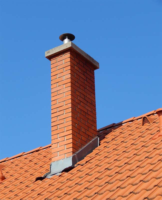 red brick chimney on a red roof
